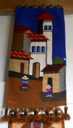 Wandteppich mit der Darstellung eines
                              Dorfzentrums