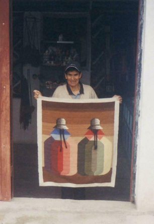 Neighbor Honorato showing one of his
                        tapestries (span. tejido)
